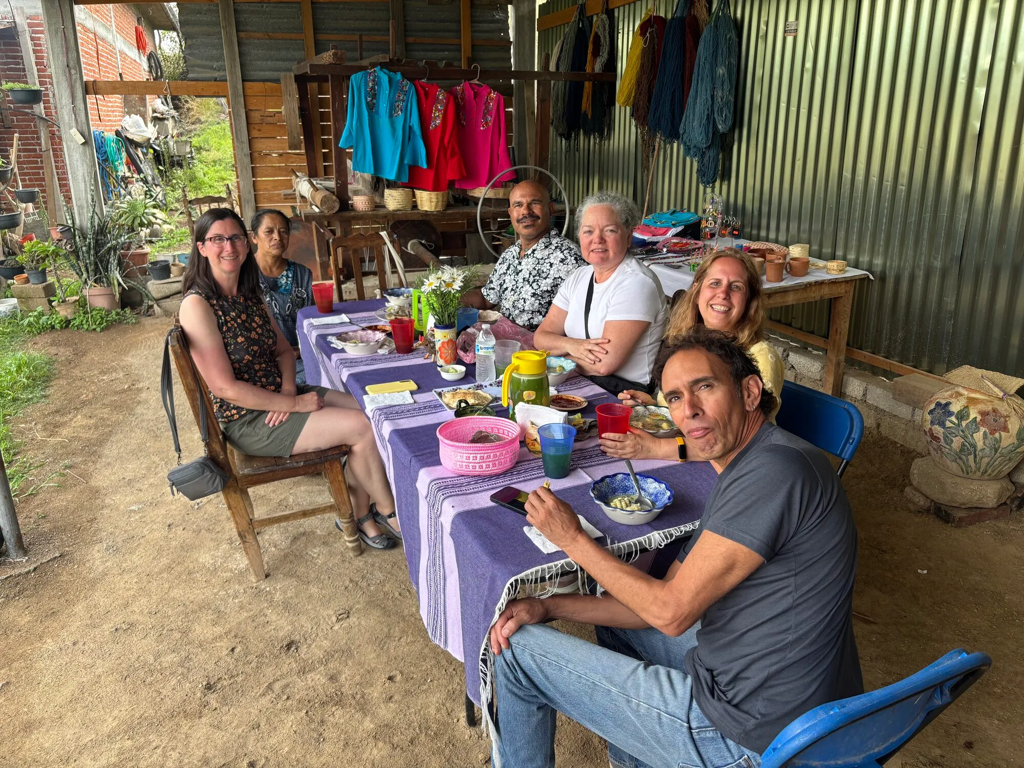 Tour group sharing a meal with a local family